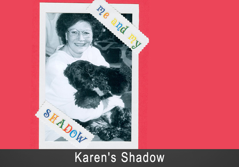 Woman holding her black dog shadow