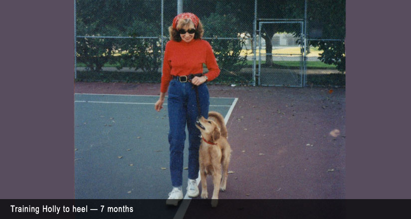 Women walking her dog on a tennis court.